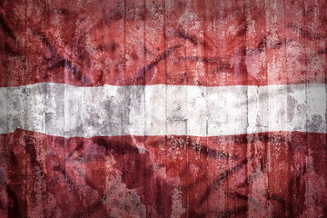 Grunge style of Latvia flag on a brick wall