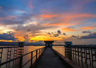 Fototapeta premium Long exposure of abandoned bridge at Bang Phra Reservoir in the Sun rise , Si Racha District , Chonburi Province, Thailand