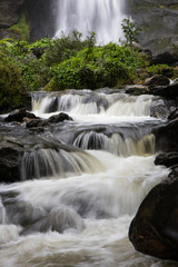 Below the waterfall rocks.