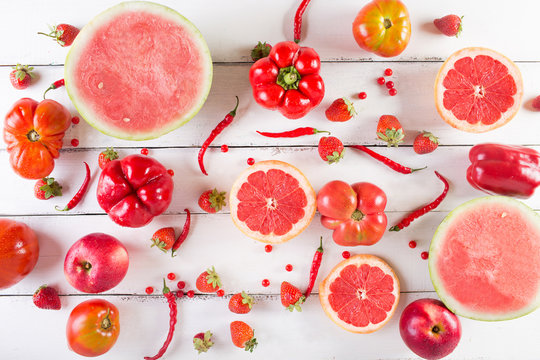 Red Fruits And Vegetables On A White On A Wooden Background