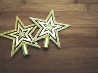Golden Christmas stars on wooden background with color design for vintage feeling