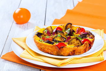 frittata with red onion, eggplant, tomato sprinkled with parsley