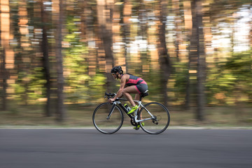 Sportive girl rides a bike