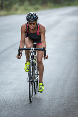Athletic girl rides a bike
