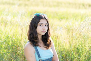 Portrait of sad teen girl on nature