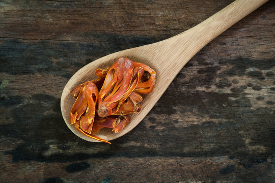 Mace or Javitri Spice on wooden spoon over wooden background