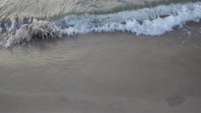 Waves lapping on the shore/wave comes to shore