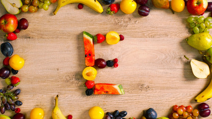 Fruits made letter E. Alphabet on a table. Summer harvest generates letters. E