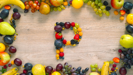 Fruits made letter P. The letters are made up of fruits. The composition of bright ripe fruits. P