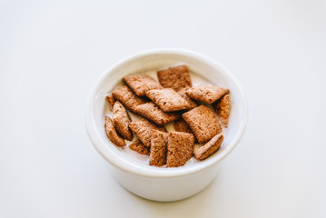 Cereals with yoghurt isolated on white table. Horizontal composition, space for copy