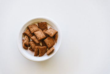 Cereals with yoghurt isolated on white table. Horizontal composition, top view, space for copy