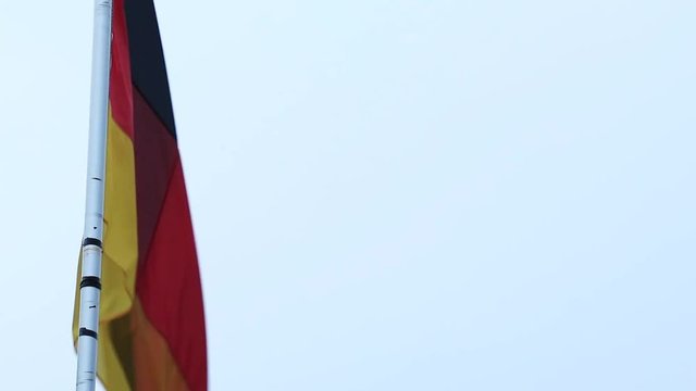 Germany flag on a flagpole blowing in the wind