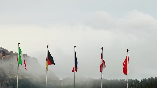 Flags of the world on a flagpole blowing in the wind