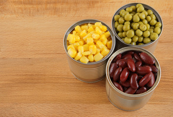 Canned food on wooden background