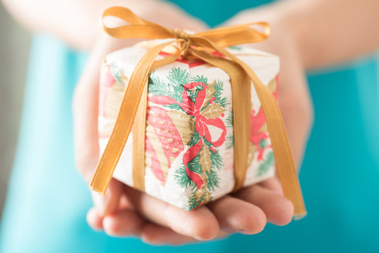 Woman holding gift box by hand