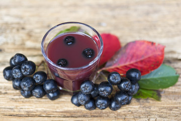 A glass of tincture of chokeberry.