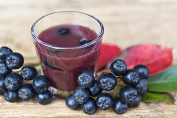 A glass of tincture of chokeberry.