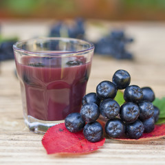 A glass of tincture of chokeberry.