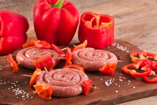 Raw sausage on wooden table.