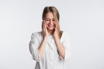 Young female doctor or nurse is shocked with hands on her mouth