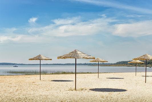 Sunshades on the beach at the lake.