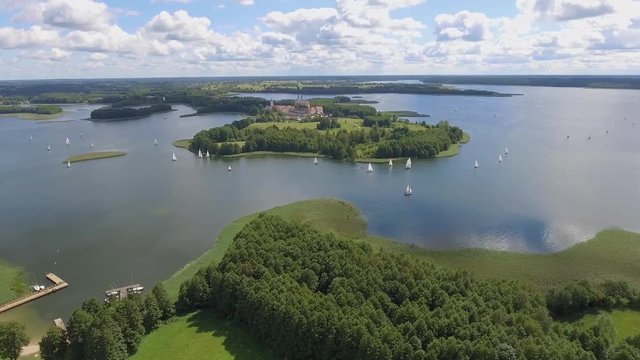 View of small islands on the lake in Masuria and Podlasie district, Poland. Blue water and whites clouds. Summer time. View from above.