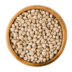 Sweet lupin beans in a wooden bowl on white background, also lupini beans, are the seeds of...