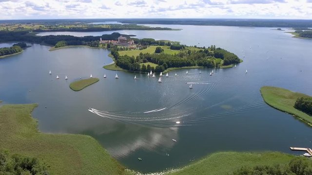 View of small islands on the lake in Masuria and Podlasie district, Poland. Blue water and whites clouds. Summer time. View from above.