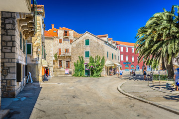 Fototapeta na wymiar Mediterranean promenade Supetar Croatia. / View at mediterranean colorful promenade in old city center of town Supetar, island Brac, Croatia.