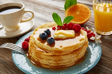 pancakes breakfast syrup coffe and orange juice