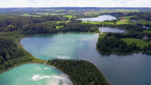View of small islands on the lake in Masuria and Podlasie district, Poland. Blue water and whites clouds. Summer time. View from above.