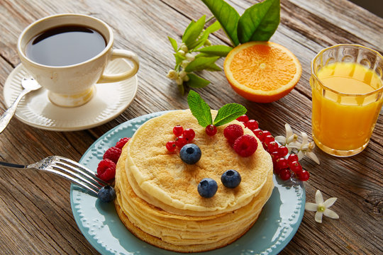 pancakes breakfast syrup coffe and orange juice
