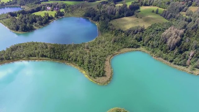 View of small islands on the lake in Masuria and Podlasie district, Poland. Blue water and whites clouds. Summer time. View from above.