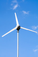 View from below of a windmill for electric power production. Outdoors.