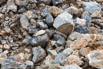 Many large rock pile with soil.