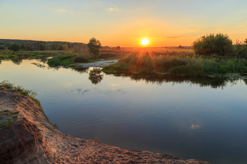 Sunset landscape on Siversky Donets plain river captured from cliff edge.