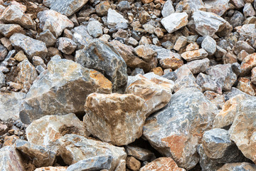 Many large rock pile with soil.
