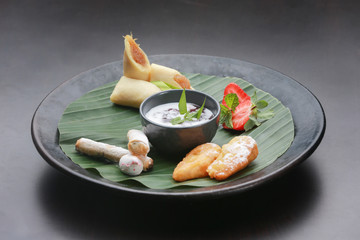 Traditional indonesian desserts on the wooden plate
