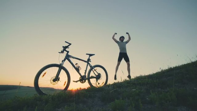 Happy guy jum and jump on the sunset background