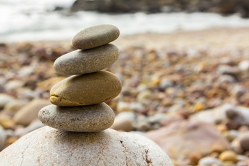 Fototapeta na wymiar Round stones decorative colors stacked on beach