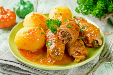 Meat rolls stuffed with bacon and pickled cucumber