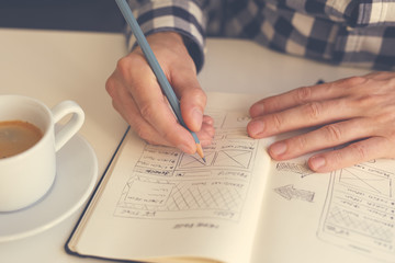 Man sketching graphic sketch in office