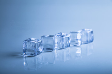 Ice cubes on blue background studio shot photo
