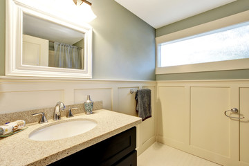 Bathroom interior in white and blue tones with black vanity cabi