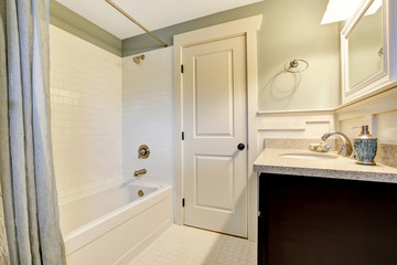 Fototapeta na wymiar Bathroom interior in white and blue tones with black vanity cabi