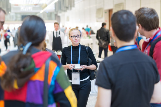 People interacting during coffee break at medical or scientific conference.