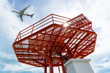 Airplane flying above radar antenna