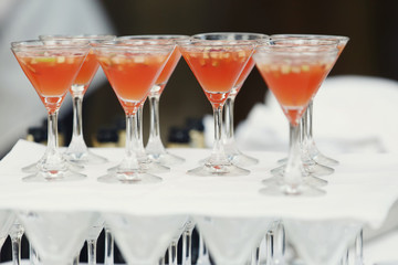 A lot of wine glasses with red apple punch