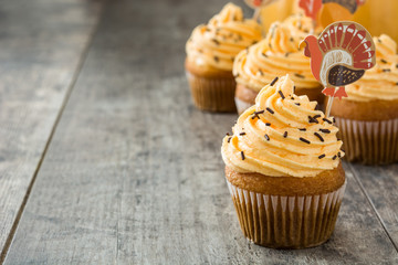 Thanksgiving cupcakes on wooden background

