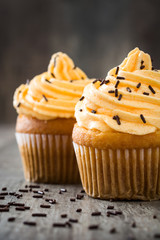 Orange cupcakes on wooden background

